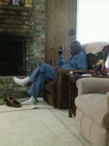 Uncle John, 90, is watching sports on TV while his wife is in the kitchen making dinner. (Maresha Carrie copyright 2014)